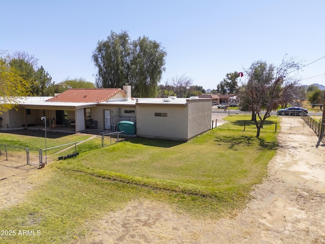 18622 E Via De Arboles, Queen Creek, AZ 85142 - back of house featuring a gate, fence, stucco siding, a tiled roof, and a lawn