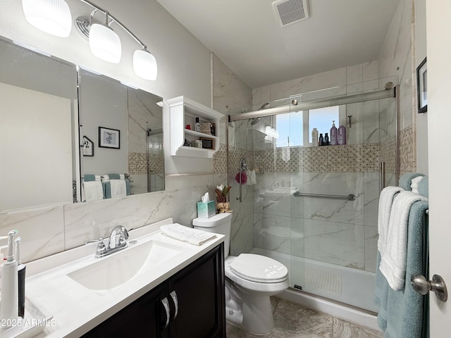 bathroom featuring vanity, visible vents, a shower stall, toilet, and backsplash