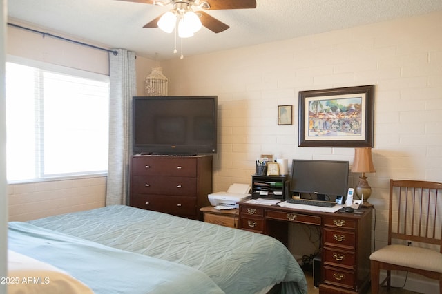 bedroom featuring a textured ceiling and a ceiling fan