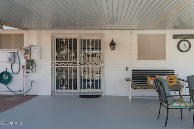 doorway to property with concrete block siding