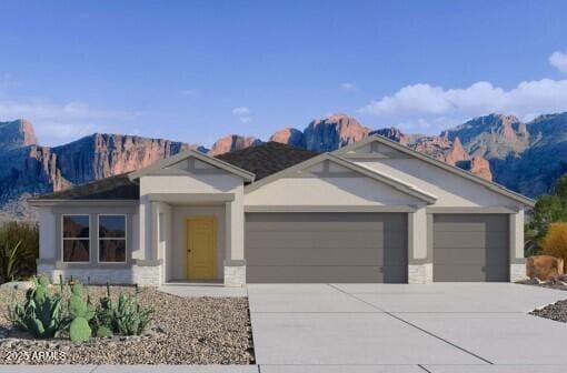 view of front of house featuring driveway, a mountain view, an attached garage, and stone siding