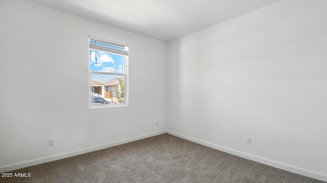 unfurnished room featuring baseboards and carpet flooring