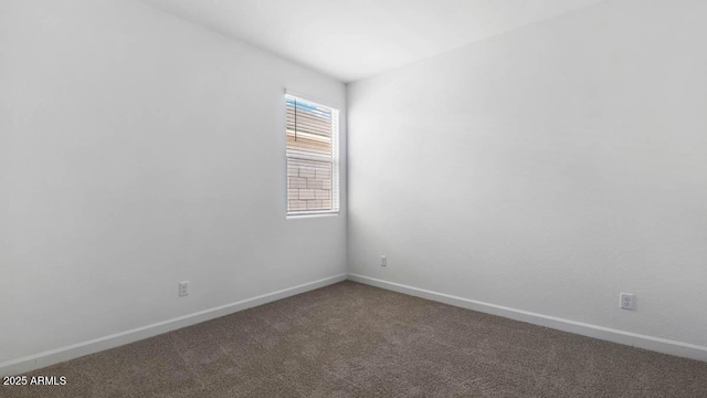 carpeted spare room with baseboards