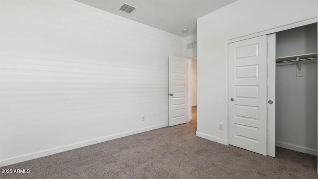 unfurnished bedroom with visible vents, baseboards, carpet flooring, and a closet
