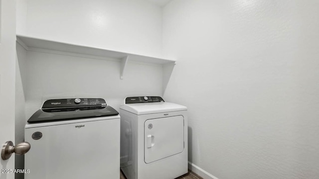 washroom with independent washer and dryer, laundry area, and baseboards