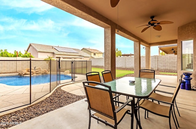 view of patio / terrace with ceiling fan and a fenced in pool