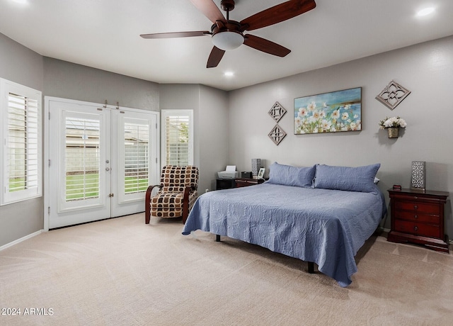 carpeted bedroom with ceiling fan, french doors, and access to outside