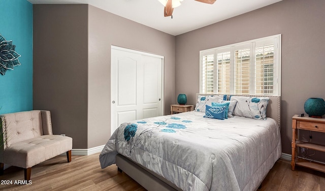 bedroom featuring a closet, hardwood / wood-style flooring, and ceiling fan