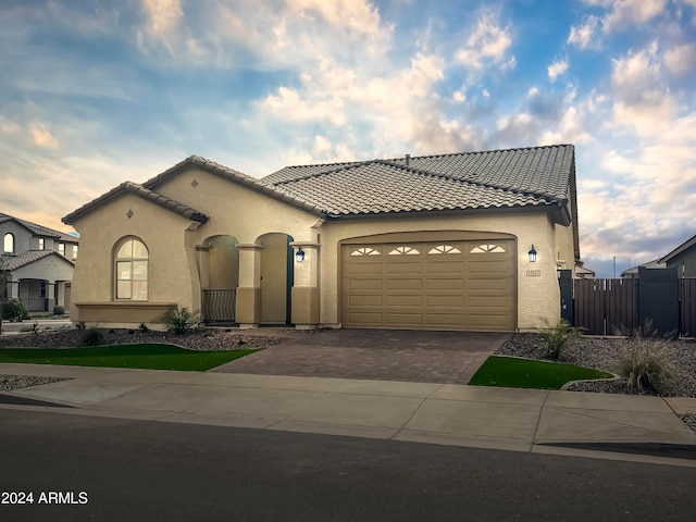 mediterranean / spanish-style home featuring a garage