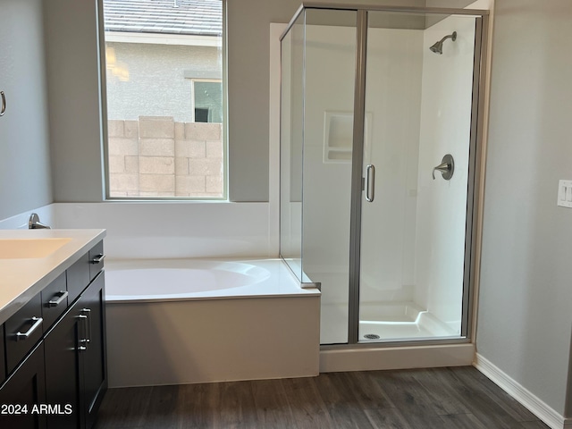 bathroom with vanity, plus walk in shower, and hardwood / wood-style flooring