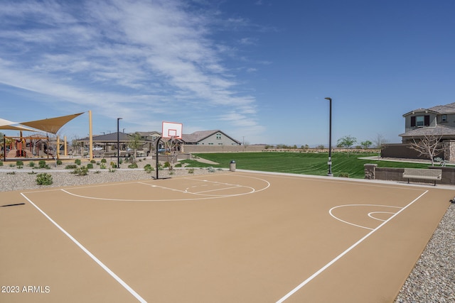 view of basketball court with a lawn