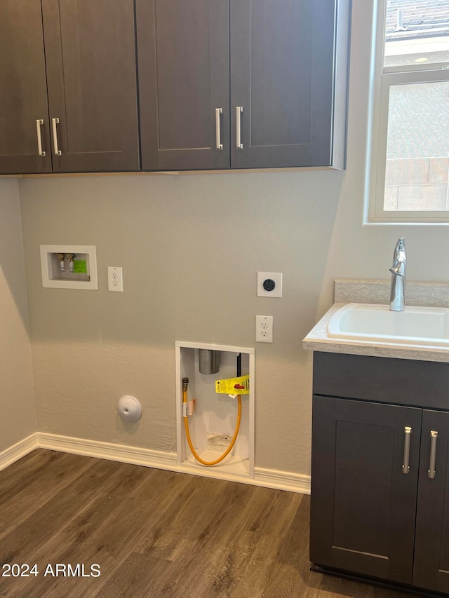 washroom featuring sink, dark wood-type flooring, hookup for an electric dryer, and washer hookup