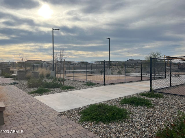 view of home's community featuring tennis court