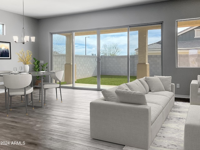 living room with a chandelier, plenty of natural light, and hardwood / wood-style floors