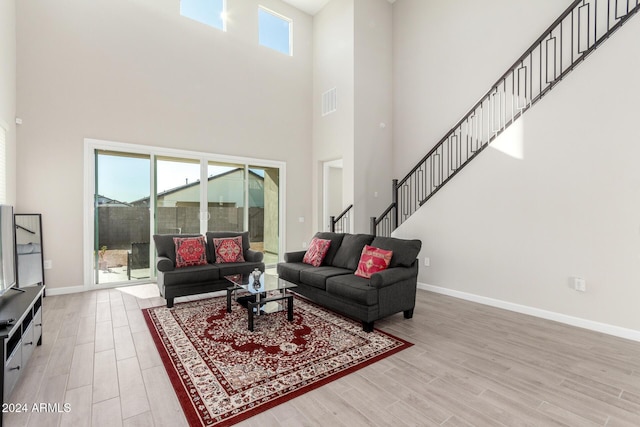 living room featuring hardwood / wood-style flooring and a high ceiling