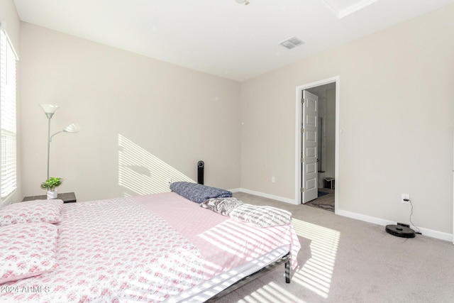 carpeted bedroom with ensuite bath