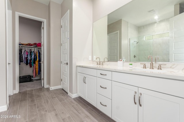 bathroom featuring hardwood / wood-style floors, vanity, and an enclosed shower