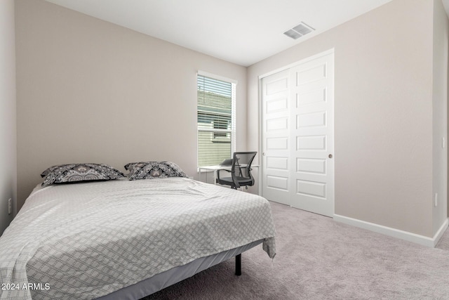 carpeted bedroom featuring a closet