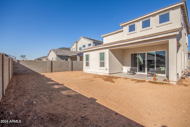 rear view of property featuring a patio area