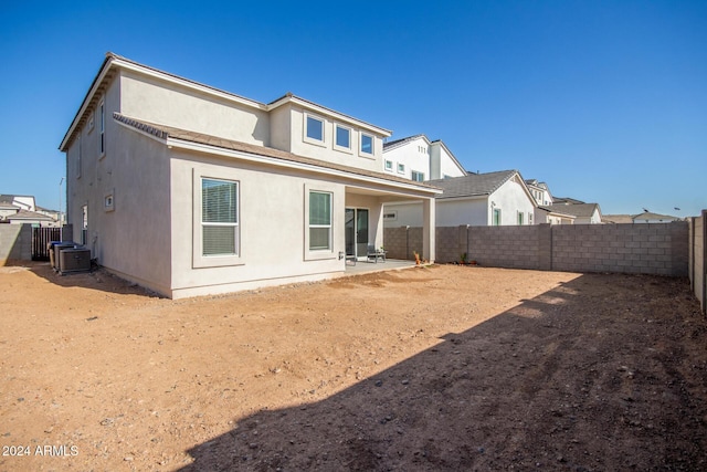 rear view of house featuring central AC