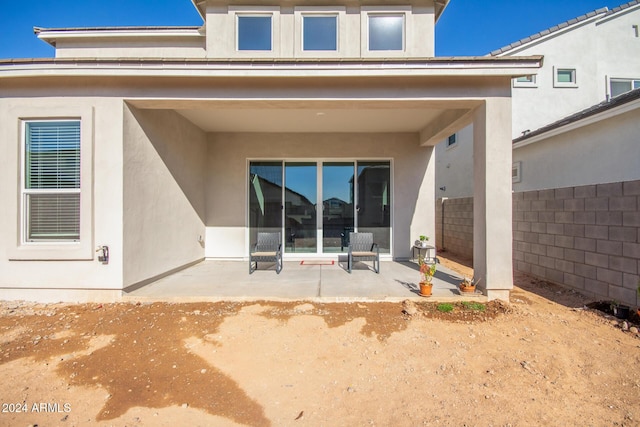 back of property featuring a patio area