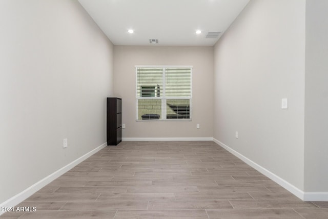 empty room with light hardwood / wood-style flooring