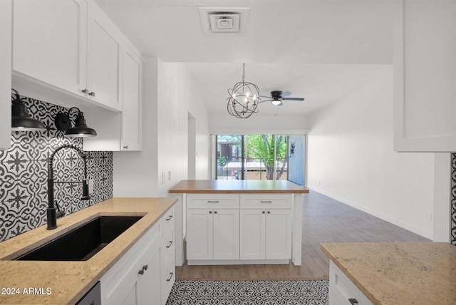 6125 E Indian School Rd Unit 240, Scottsdale, AZ 85251 - kitchen with a sink, white cabinetry, light wood-style flooring, and a peninsula