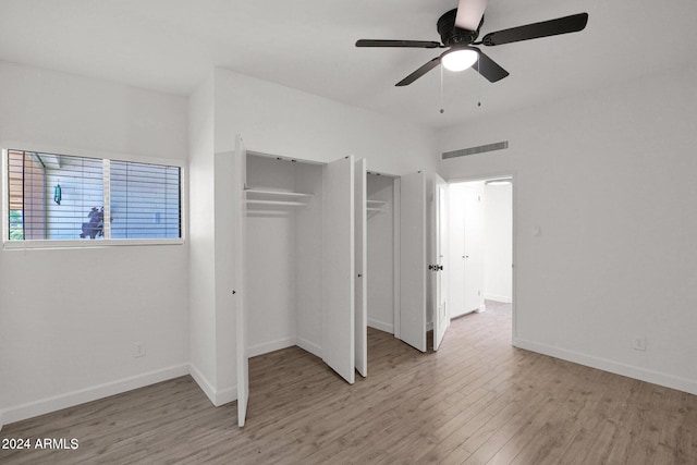 6125 E Indian School Rd Unit 240, Scottsdale, AZ 85251 - unfurnished bedroom with wood finished floors, baseboards, and ceiling fan