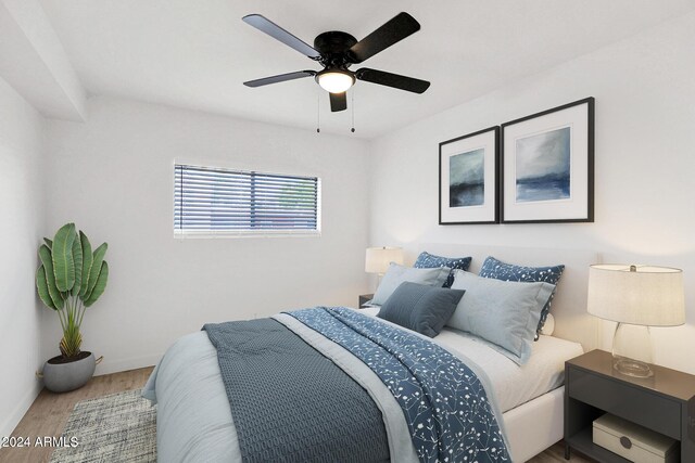 6125 E Indian School Rd Unit 240, Scottsdale, AZ 85251 - bedroom featuring wood finished floors, a ceiling fan, and baseboards