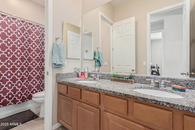 bathroom featuring double vanity, toilet, a shower with shower curtain, and tile patterned floors