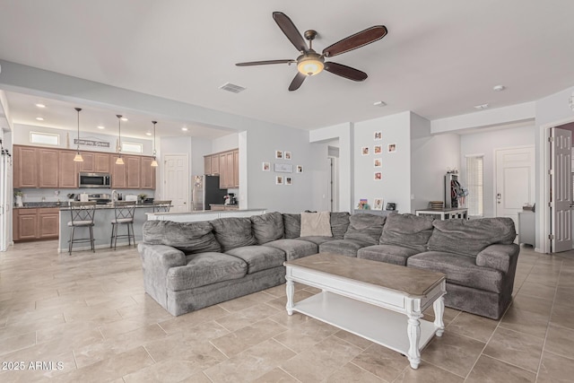 living area featuring a ceiling fan and recessed lighting