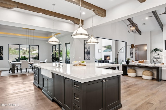 13750 E Yucca St, Scottsdale, AZ 85259 - kitchen with a sink, open floor plan, light countertops, beam ceiling, and light wood-style floors