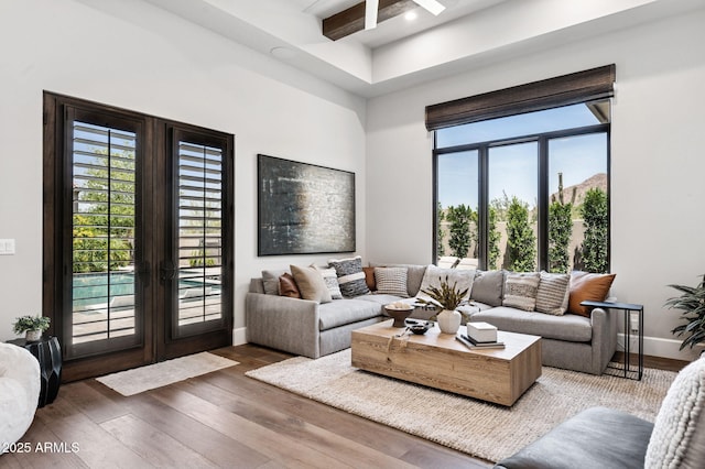 13750 E Yucca St, Scottsdale, AZ 85259 - living room featuring wood finished floors, healthy amount of natural light, baseboards, french doors, and beamed ceiling