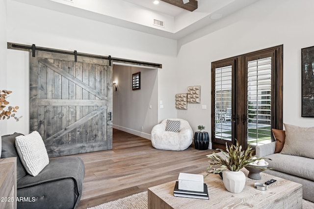 13750 E Yucca St, Scottsdale, AZ 85259 - living area featuring a barn door, wood finished floors, recessed lighting, baseboards, and french doors