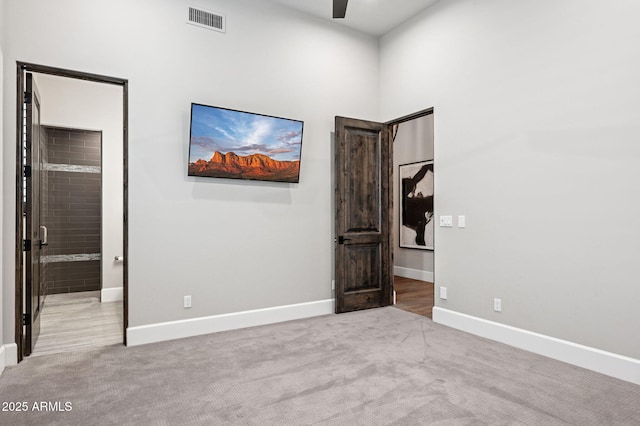 13750 E Yucca St, Scottsdale, AZ 85259 - unfurnished bedroom featuring light colored carpet, baseboards, and ensuite bath