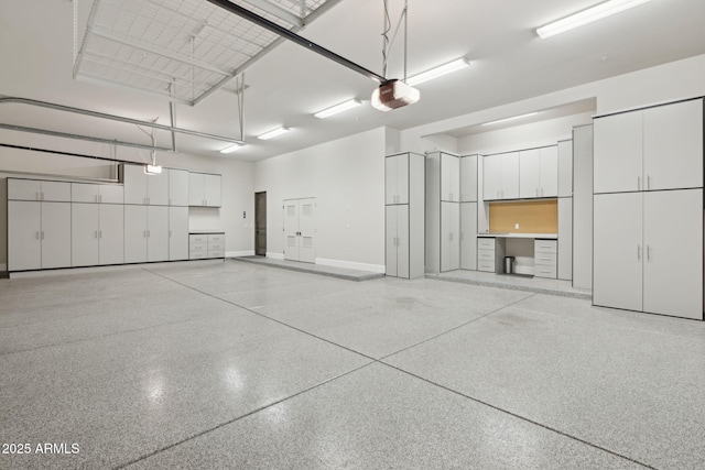13750 E Yucca St, Scottsdale, AZ 85259 - garage featuring a garage door opener and baseboards