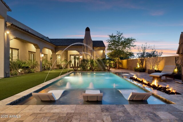 13750 E Yucca St, Scottsdale, AZ 85259 - pool at dusk featuring a fire pit and a patio area