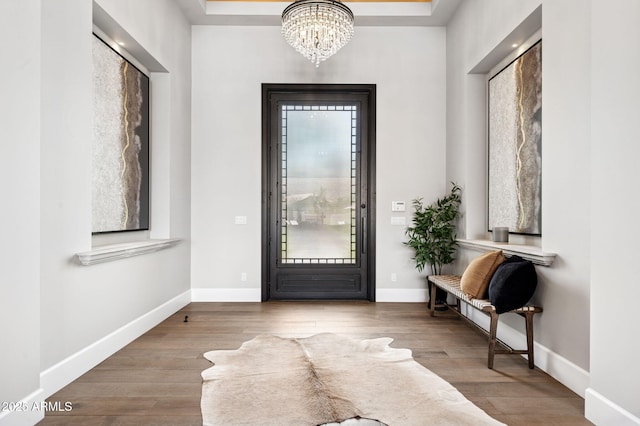 13750 E Yucca St, Scottsdale, AZ 85259 - foyer with a chandelier, wood finished floors, baseboards, and a raised ceiling