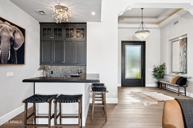 13750 E Yucca St, Scottsdale, AZ 85259 - bar area with a chandelier, dark wood-type flooring, baseboards, decorative backsplash, and recessed lighting