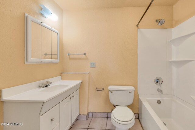 full bathroom with  shower combination, toilet, tile floors, and vanity with extensive cabinet space