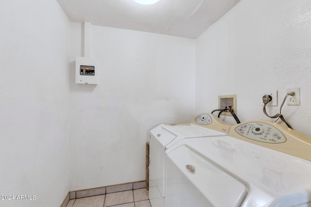 clothes washing area featuring hookup for an electric dryer, separate washer and dryer, light tile floors, and hookup for a washing machine