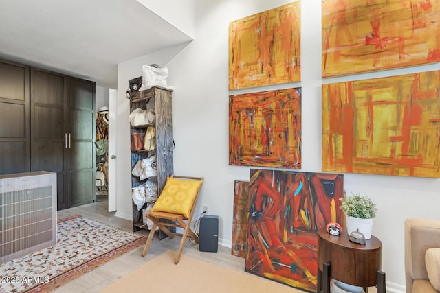 sitting room featuring heating unit and wood-type flooring