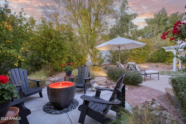 patio terrace at dusk with a fire pit