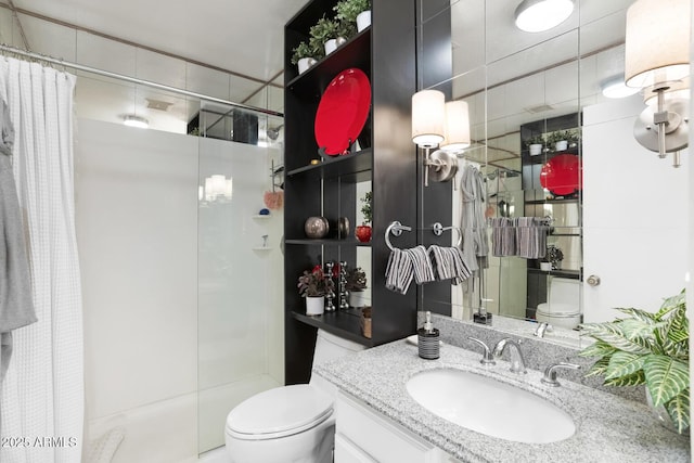 bathroom featuring curtained shower, vanity, tile walls, and toilet