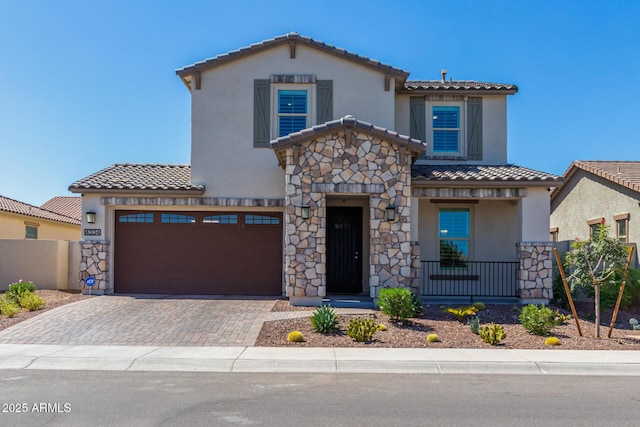 mediterranean / spanish-style home with a garage