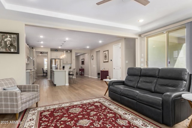 living room featuring ceiling fan and light wood-type flooring