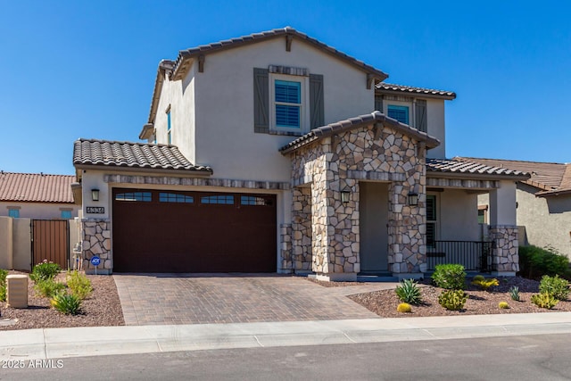 mediterranean / spanish home with a garage