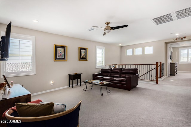 living room featuring ceiling fan and light colored carpet