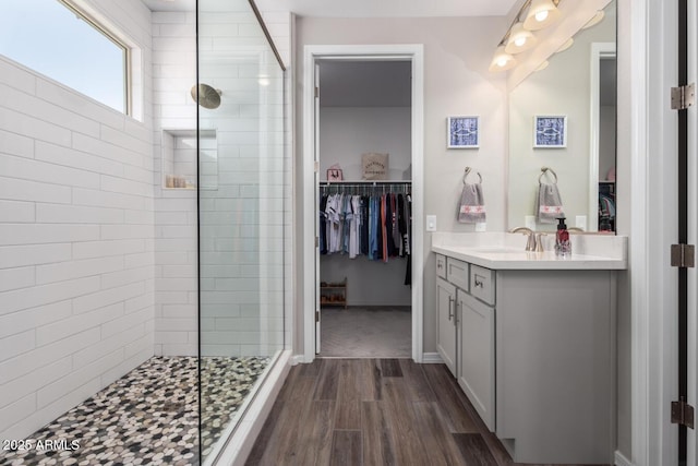 bathroom with vanity, a shower with door, and hardwood / wood-style floors