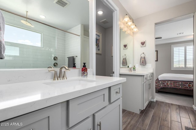 bathroom with vanity and tiled shower